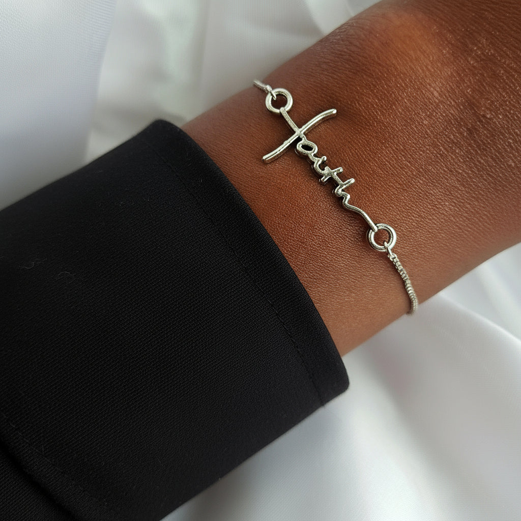 Bracelet with &#39;faith&#39; on a wrist wearing a beige sweater.